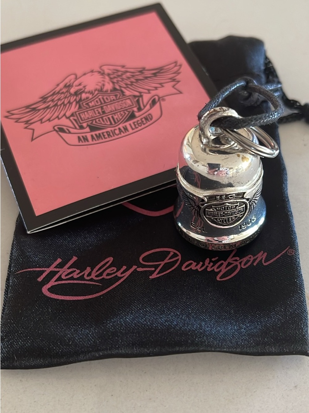 Harley-Davidson Silver Bell Pendant on Black Cord with Pink Logo Pouch